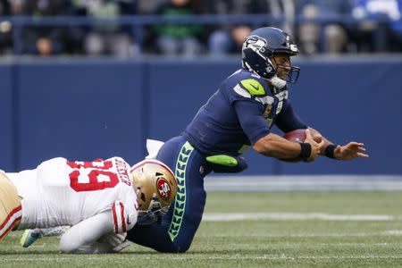 Dec 2, 2018; Seattle, WA, USA; Seattle Seahawks quarterback Russell Wilson (3) is sacked by San Francisco 49ers defensive tackle DeForest Buckner (99) during the third quarter at CenturyLink Field. Mandatory Credit: Joe Nicholson-USA TODAY Sports