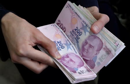 A merchant counts Turkish lira banknotes at the Grand Bazaar in Istanbul