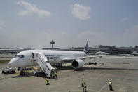 An Airbus A350-900 test plane is seen at Singapore's Changi Airport at a media preview ahead of the upcoming Singapore Air Show on Monday, Feb. 10, 2014. Airbus is showing off its new wide-body A350 at Asia's biggest airshow this week. It's a strong sign the European plane maker is on schedule to start delivering the advanced jet to airline customers in the second half of the year. (AP Photo/Joseph Nair)