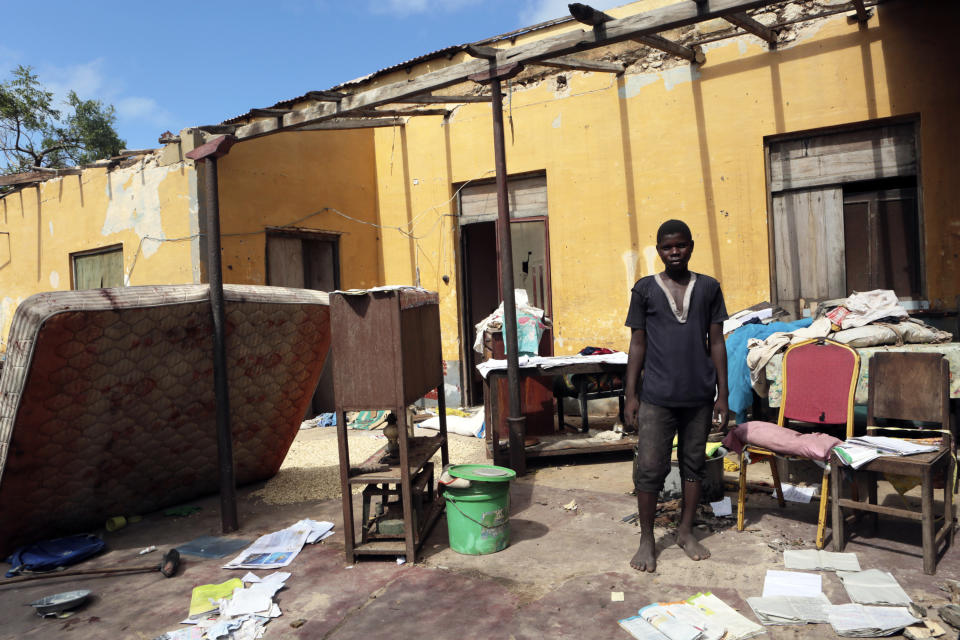 A man stands next to his house which got damaged by Cyclone Kenneth when it struck Ibo island north of Pemba city in Mozambique, Wednesday, May, 1, 2019. The government has said more than 40 people have died after the cyclone made landfall on Thursday, and the humanitarian situation in Pemba and other areas is dire. More than 22 inches (55 centimeters) of rain have fallen in Pemba since Kenneth arrived just six weeks after Cyclone Idai tore into central Mozambique. (AP Photo/Tsvangirayi Mukwazhi)