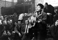 <p>Following his record deal, Dylan released his debut, eponymous album in March 1962, but it wasn't until the release of his second album, and the help of newly-signed manager Albert Grossman, that he began to create a name for himself as a singer-songwriter.</p> <p>Titled <i>The Freewheelin' Bob Dylan</i>, the record consisted of several tracks labeled as protest songs due to their underlying political and social themes and lyrics (partly inspired by Guthrie).</p> <p>The lead song "Blowin' in the Wind" is in part derived from the African-American spiritual, "<a href="https://www.rollingstone.com/music/music-news/50-years-ago-today-bob-dylan-premiered-blowin-in-the-wind-201983/" rel="nofollow noopener" target="_blank" data-ylk="slk:No More Auction Block" class="link ">No More Auction Block</a>," while "A Hard Rain's a-Gonna Fall" eluded to an impending apocalypse <a href="https://www.nbcnews.com/pop-culture/music/bob-dylans-hard-rains-a-gonna-fall-lyrics-be-auctioned-n415671" rel="nofollow noopener" target="_blank" data-ylk="slk:amid the Cuban Missile Crisis" class="link ">amid the Cuban Missile Crisis</a>. </p> <p><i>The Freewheelin' Bob Dylan</i> not only experimented with different sounds, like rockabilly and blues, but the album's songs established Dylan as the voice of his generation as his lyrics resonated with listeners and understood Americans' concerns on political and social issues of the day.</p>