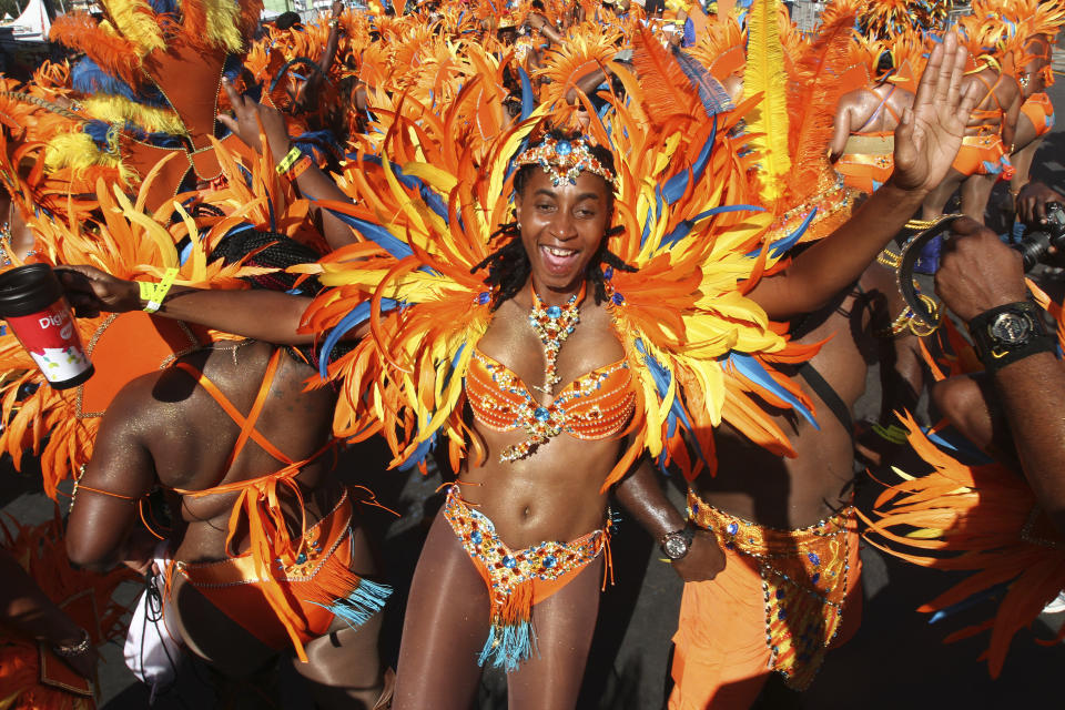 PORT OF SPAIN, TRINIDAD - FEBRUARY 17:  Masqueraders from the band &#39;Ah Come Back Home&#39; by Ronnie & Caro dance in the Queen&#39;s Park Savannah during the Parade of Bands as part of Trinidad and Tobago Carnival on February 17, 2015 in Port of Spain, Trinidad. (Photo by Sean Drakes/LatinContent via Getty Images)