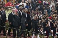 U.S. President Barack Obama (centre L), flanked by India's Prime Minister Narendra Modi (in turban), the first lady Michelle Obama (centre R), and his Indian counterpart Pranab Mukherjee (R) wave as they leave after attending the Republic Day parade in New Delhi January 26, 2015. Obama watched a dazzling parade of India's military might and cultural diversity on Monday, the second day of a visit trumpeted as a chance to establish a robust strategic partnership between the world's two largest democracies. REUTERS/Adnan Abidi