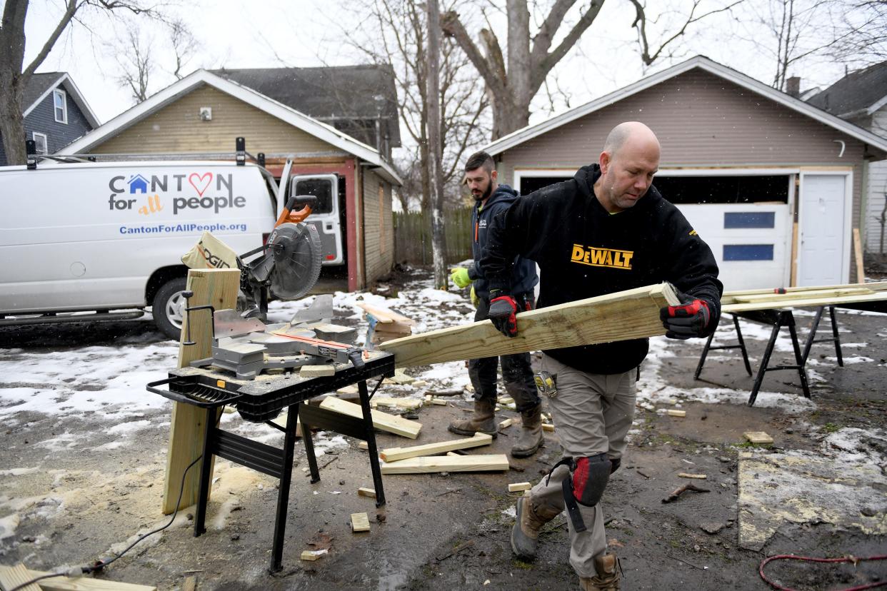 Mike Varn, left, and Ken Strobel with Canton For All People, work to refurbish a home on Ninth Street NW as work continues in coordination with the city to revitalize the greater Shorb area.