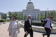 Lt. Gov Spencer Cox, center, joined by his running mate Sen. Deidre Henderson, R-Spanish Fork, arrive for a press conference at the Utah State Capitol Tuesday, July 7, 2020, in Salt Lake City. Jon Huntsman Jr. was narrowly beaten Monday, July 6, 2020, by Cox, who had heightened visibility as he helped respond to the coronavirus and managed to pitch himself as an earnest politician with rural Utah roots. (AP Photo/Rick Bowmer)