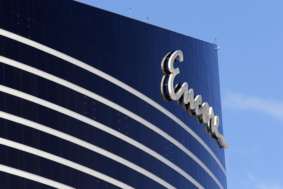 FILE - In this May 22, 2019 file photo, Encore Boston Harbor casino logo looms above the surrounding neighborhood in Everett, Mass. The casino is scheduled to open on Sunday, June 23. (AP Photo/Michael Dwyer, File)