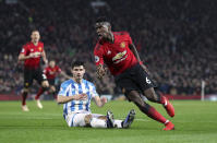 Manchester United's Paul Pogba, right, celebrates scoring against Huddersfield during the English Premier League soccer match at Old Trafford, Manchester, England, Wednesday Dec. 26, 2018. (Martin Rickett/PA via AP)