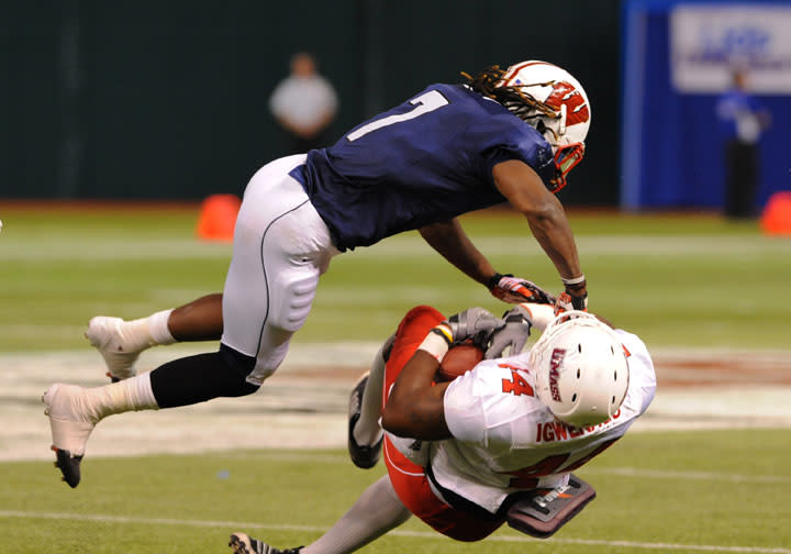 ST. PETERSBURG, FL - JANUARY 21: Defensive back Aaron Henry #7 of the Wisconsin Badgers tackles tight end Emil Igwenagu #44 of the University of Massachuttes Minutemen during the 87th annual East-West Shrine game January 21, 2012 at Tropicana Field in St. Petersburg, Florida. (Photo by Al Messerschmidt/Getty Images)