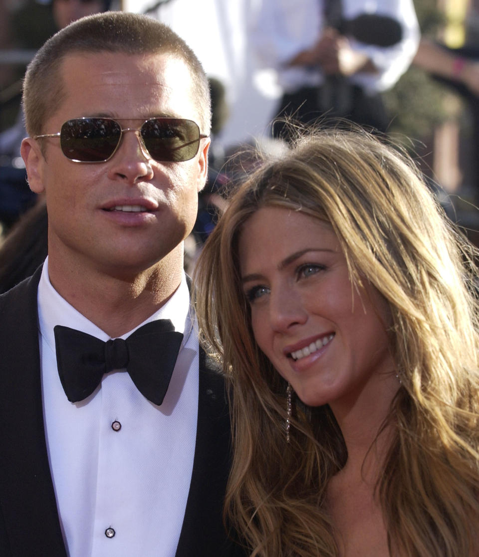 Jennifer Aniston, right, and husband Brad Pitt pose for photographers on as they arrive for the 56th Annual Primetime Emmy Awards, at the Shrine Auditorium in Los Angeles. Aniston is nominated for outstanding lead actress in a comedy series for her work on "Friends EMMYS, LOS ANGELES, USA
