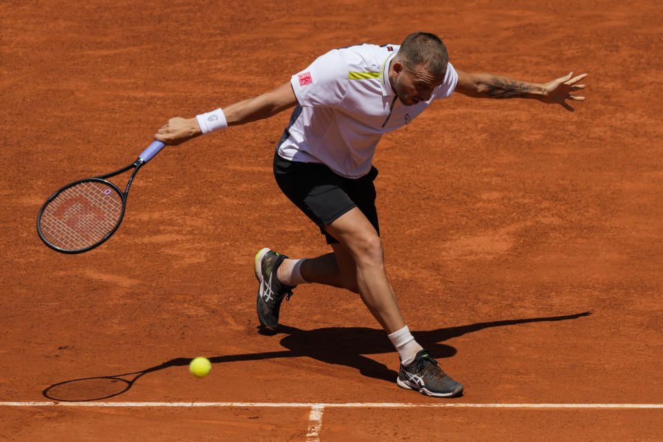 Daniel Evans of Britain returns the ball during a match against Andrey Rublev of Russia at the Mutua Madrid Open tennis tournament in Madrid, Thursday, May 5, 2022. (AP Photo/Bernat Armangue)