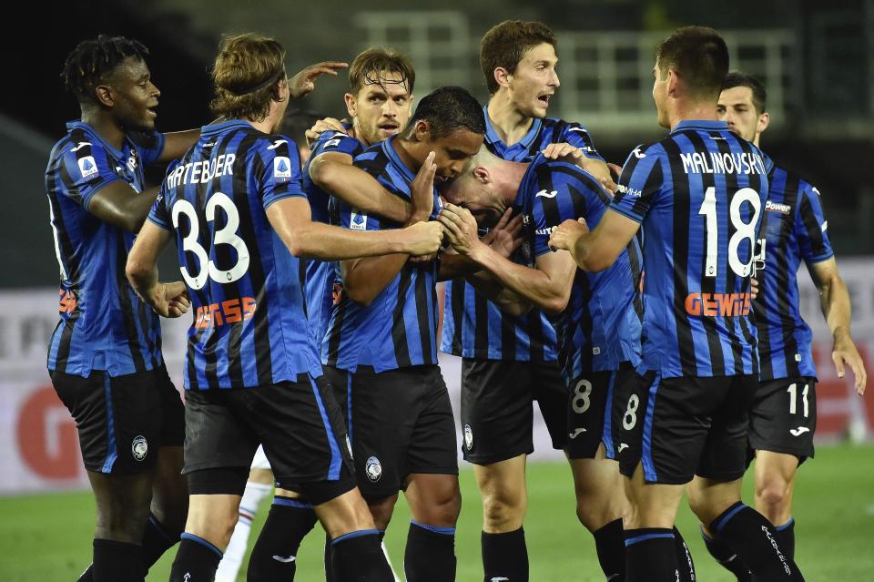 Atalanta's Luis Muriel celebrates with teammates after scoring during the Serie A soccer match between Atalanta and Sampdoria at the Gewiss Stadium in Bergamo, Italy, Wednesday, July 8, 2020. (Gianluca Checchi/LaPresse via AP)