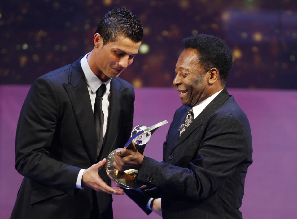 FILE - Soccer player Cristiano Ronaldo from Portugal, left, receives the trophy from former Brazilian soccer star Pele, right, after being named FIFA World Player of the Year during the FIFA World Player Gala 2008 at the Opera house in Zurich, Switzerland, Monday, Jan.12, 2009. (AP Photo/KEYSTONE/Steffen Schmidt, File)