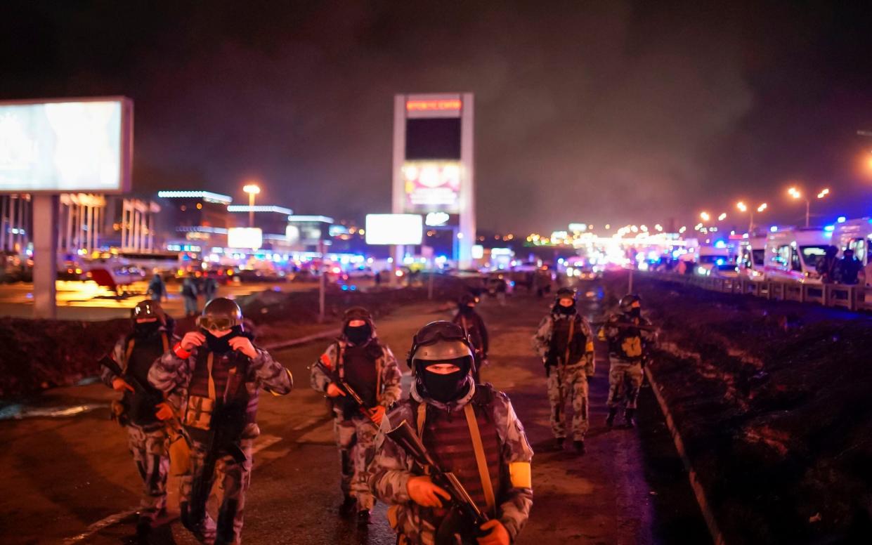 Russian Rosguardia servicemen secure an area at the Crocus City Hall on the western edge of Moscow