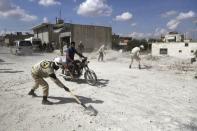 Civil defence members remove rubble from a site hit by what activists said were airstrikes carried out by the Russian air force in Kafranbel, near Idlib Syria October 10, 2015. REUTERS/Khalil Ashawi