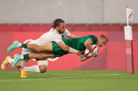 <p>CHOFU, JAPAN - JULY 26: Hugo Lennox of Team Ireland scores a try under pressure from Steve Tomasin of Team United States during the Men's Pool C Rugby Sevens match between United States and Ireland on day three of the Tokyo 2020 Olympic Games at Tokyo Stadium on July 26, 2021 in Chofu, Tokyo, Japan. (Photo by Dan Mullan/Getty Images)</p> 