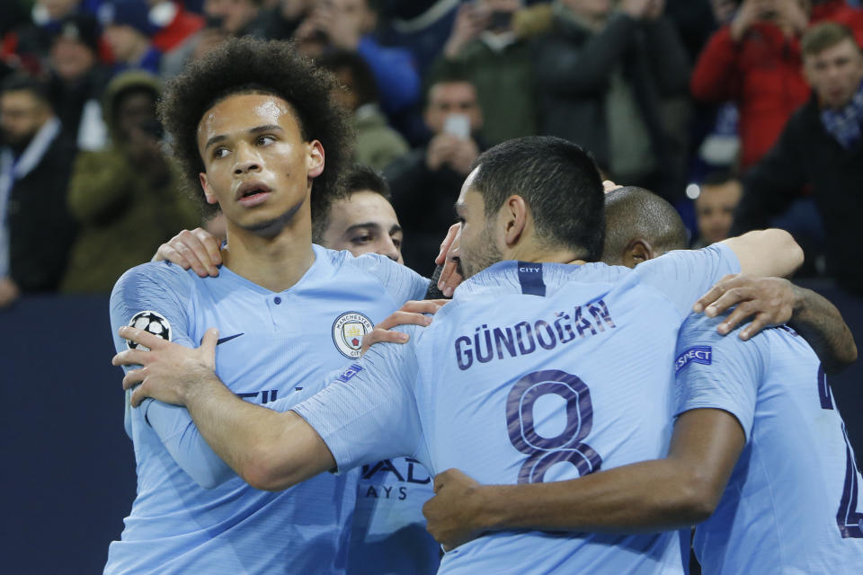 Manchester city players celebrate their third goal with midfielder Leroy Sane, left, during the first leg, round of sixteen, Champions League soccer match between Schalke 04 and Manchester City at Veltins Arena in Gelsenkirchen, Germany, Wednesday Feb. 20, 2019. (AP Photo/Michael Probst)