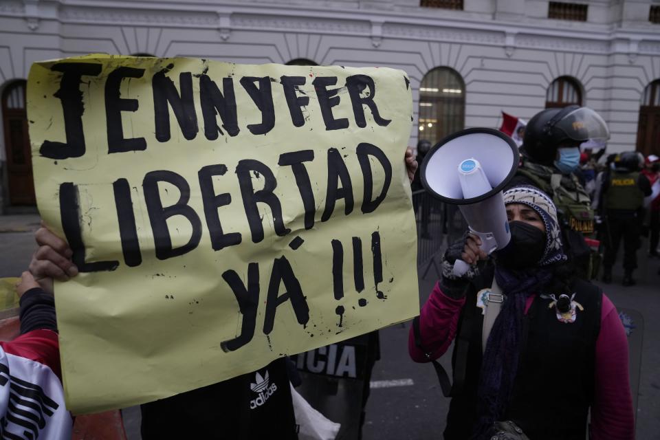 Demonstrators gather outside a court building to show support for Yenifer Paredes, the sister-in-law of Peru´s President Pedro Castillo, in Lima, Peru, Sunday, Aug. 28, 2022. A judge will decide if Paredes should be held in preventive detention for 36 months, as requested by the prosecution for her alleged participation in a corruption network. (AP Photo/Martin Mejia)