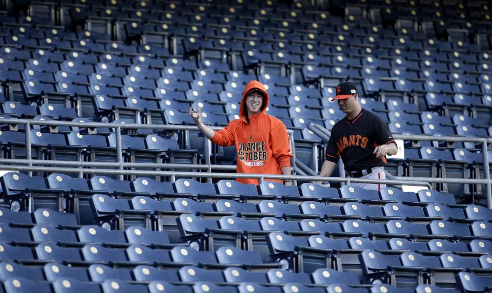 Tim Lincecum (in orange) with Tim Hudson at Kauffman Stadium on Monday. (AP)