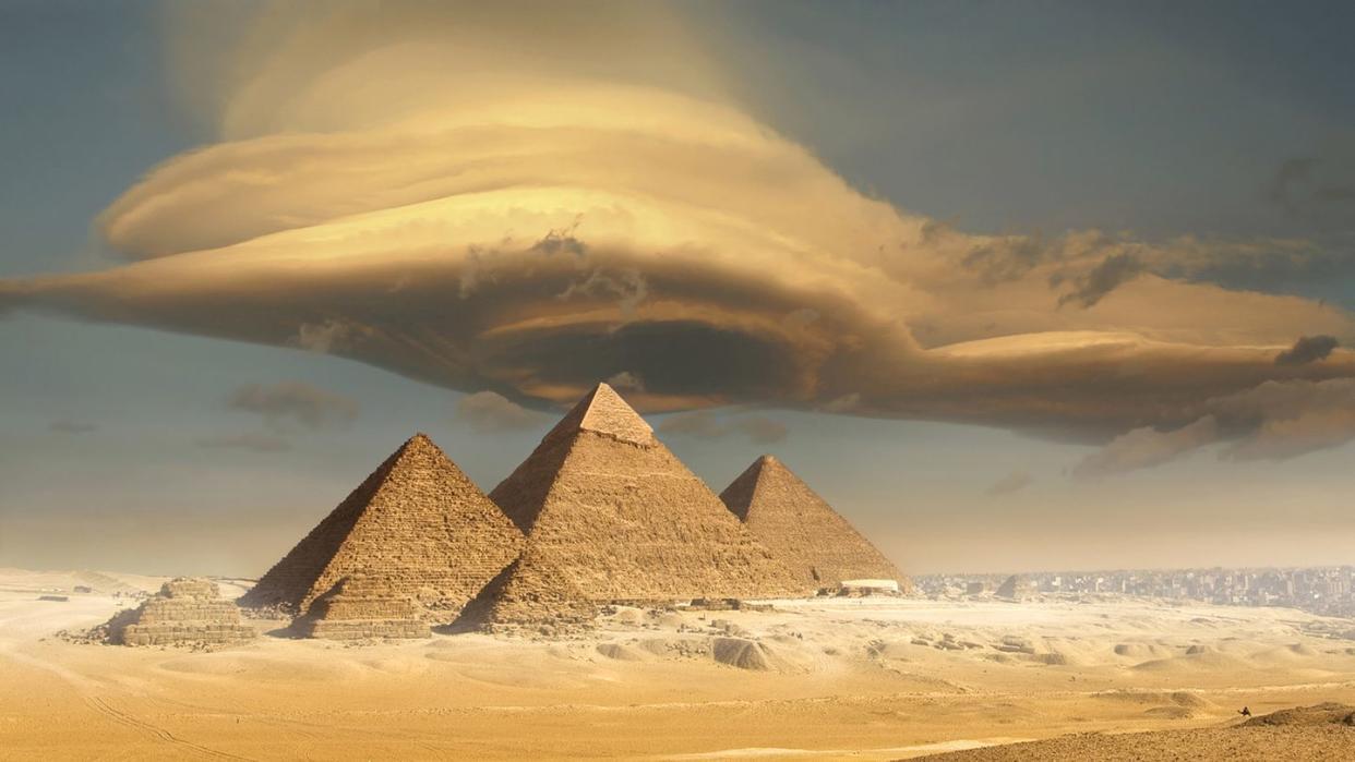 dramatic storm cloud above pyramids, giza, egypt