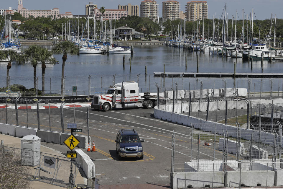 Workers begin to dismantle the track for the IndyCar Firestone Grand Prix of St. Petersburg auto race Monday, March 16, 2020, in St. Petersburg, Fla. Race organizers canceled the event to help curb the spread of the coronavirus. (AP Photo/Chris O'Meara)