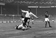 FILE - In this Oct. 23, 1965 file photo, England inside-right Jimmy Greaves vies for the ball against Yugoslav goalkeeper Milutin Soskic during the second half of the Football Association football match between England and the Rest of the World at Wembley Stadium, London. Jimmy Greaves, one of England’s greatest goal-scorers who was prolific for Tottenham, Chelsea and AC Milan has died. He was 81. With 266 goals in 379 appearances, Greaves was the all-time record scorer for Tottenham, which announced his death on Sunday, Sept. 19, 2021. (AP Photo/Robert Rider-Rider, File)