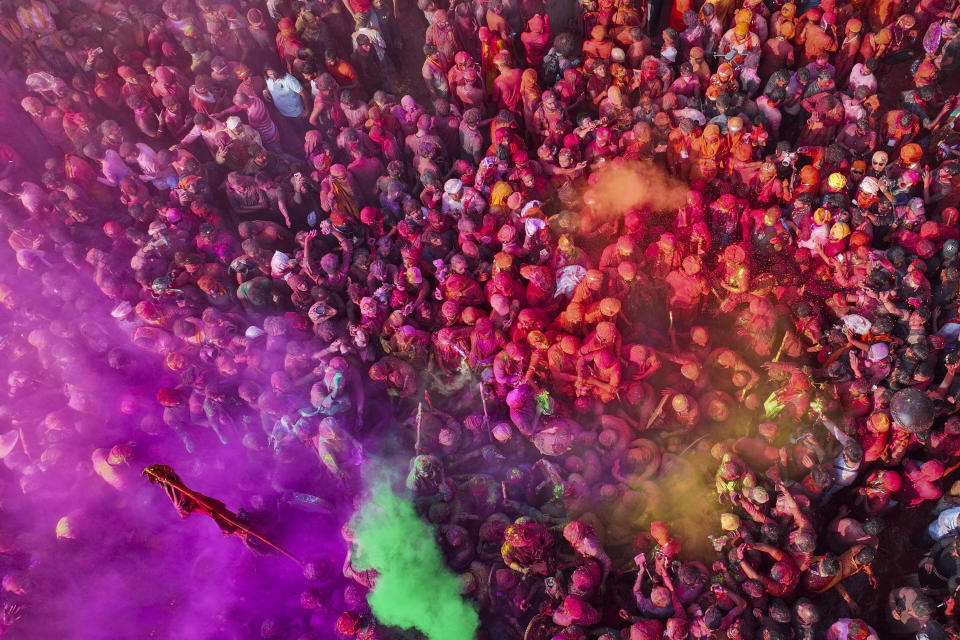 Villagers from Barsana and Nandgaon smeared with colors play Lathmar Holi at Nandagram temple in Nandgoan village, 115 kilometers (70 miles) south of New Delhi, India, Tuesday, March 19, 2024. Women from Nandgaon, the birthplace of Hindu God Krishna, beat the men from Barsana, the legendary birthplace of Radha, the consort of Krishna, with wooden sticks in response to their efforts to put color on them. The same act is then replicated in Barsana between the women of that village and the men of Nandgaon as they observe the Lathmar Holi festival, a celebration of love and friendship. (AP Photo/Rajesh Kumar Singh)