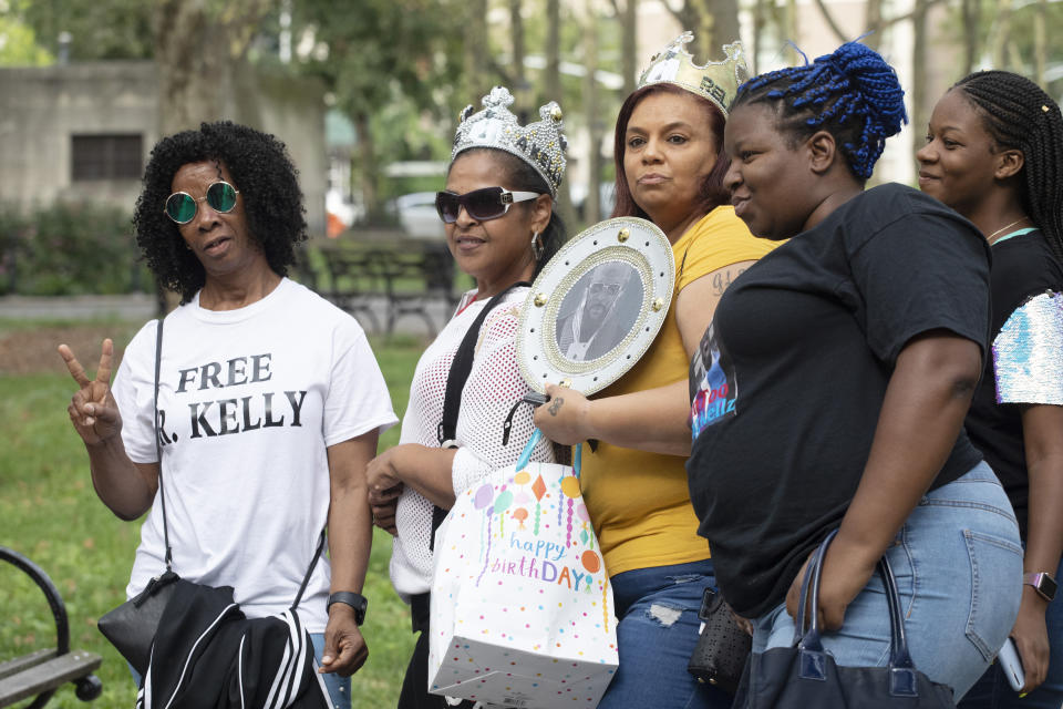 Supporters of R&B performer R. Kelly arrive at federal court in Brooklyn for his hearing, Friday, Aug. 2, 2019, in New York. Kelly faces an arraignment on charges he sexually abused women and girls. (AP Photo/Mark Lennihan)