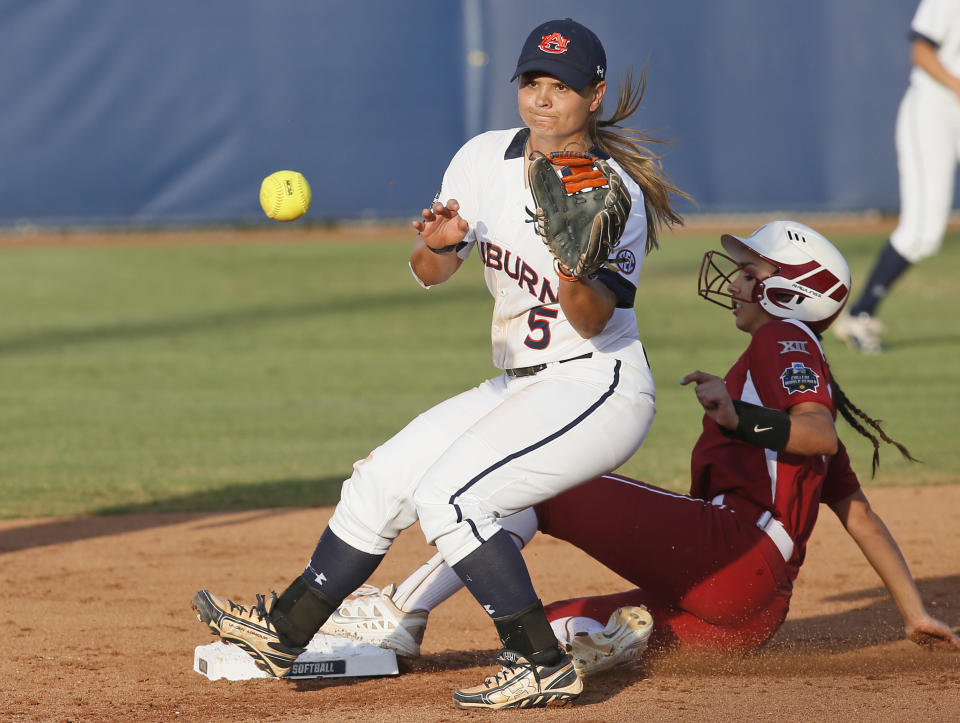 FILE - Auburn's Emily Carosone (5) waits for the late throw as Oklahoma's Raegan Rogers advances to second base on a ball hit by Kelsey Arnold during the second inning of the second game of the best-of-three championship series in the NCAA Women's College World Series in Oklahoma City, in this Tuesday, June 7, 2016, file photo. Italy’s roster for the Tokyo Games includes second baseman Emily Carosone, born in Orlando, Florida. (AP Photo/Sue Ogrocki, File)