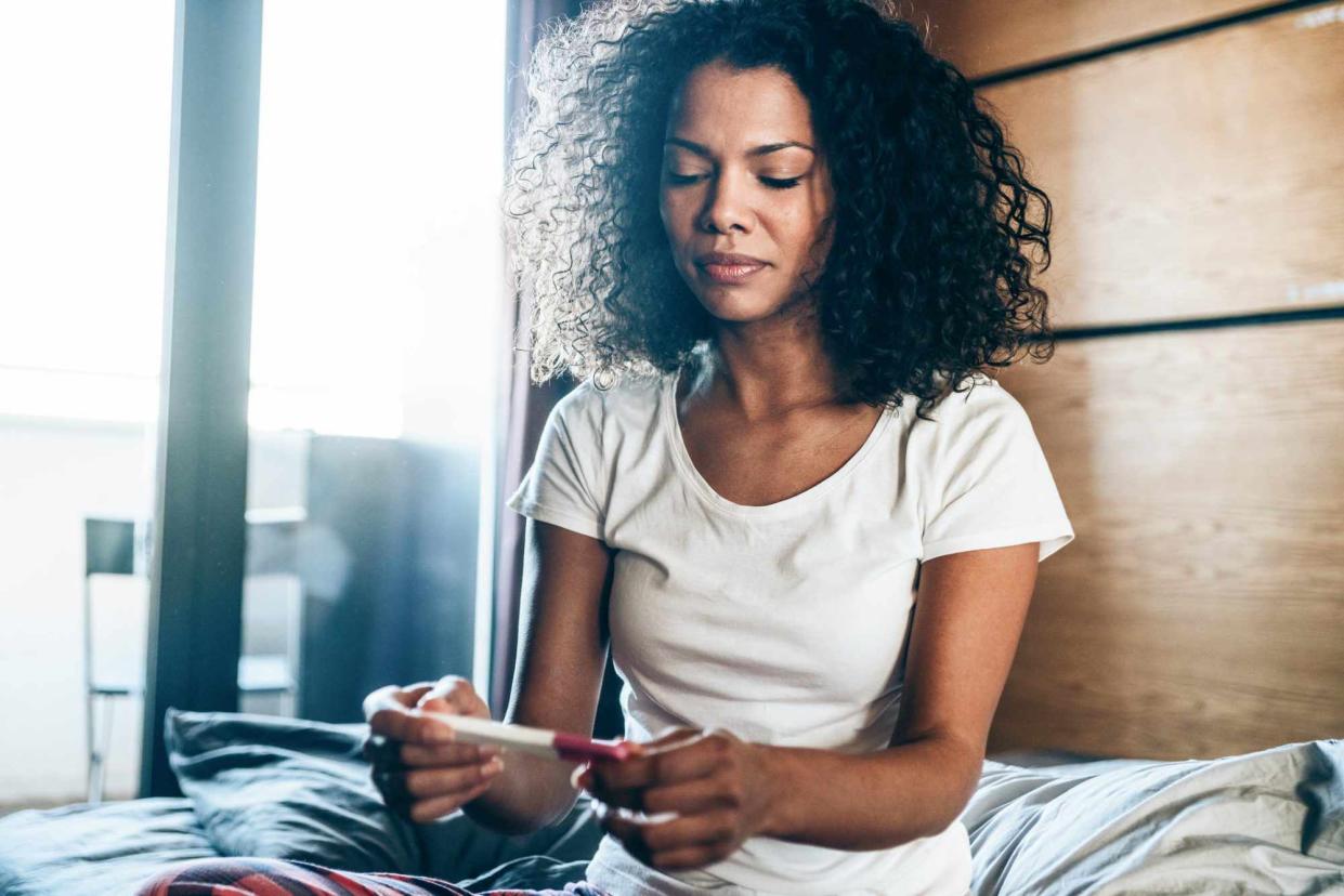 Young Woman With Pregnancy Test At Home