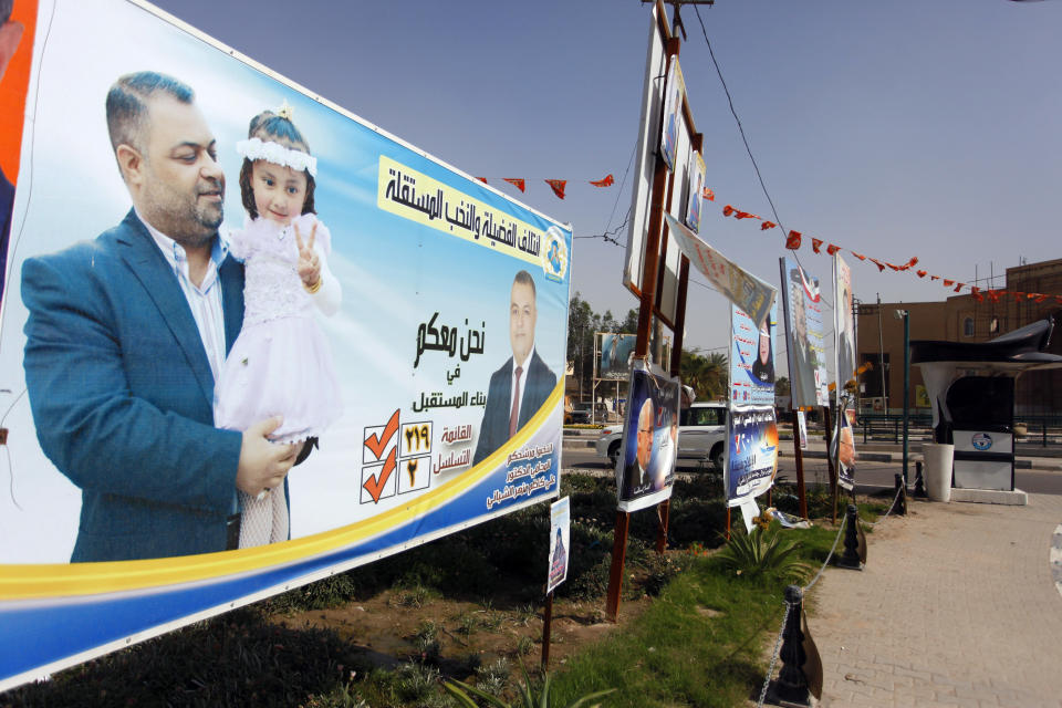 In this photo taken on April 14, 2014, an election poster depicts a candidate holding his daughter in Najaf, Iraq. Iraqis are set to cast their ballots on Wednesday to choose new legislative body in the first parliamentary elections after the U.S. army withdrawal in 2011, a vote that is expected to go along sectarian and ethnic lines. Yet, the countrymen are united on one conclusion that there is dim hope this election will bring real change and better days for them. (AP Photo/Jaber al-Helo)