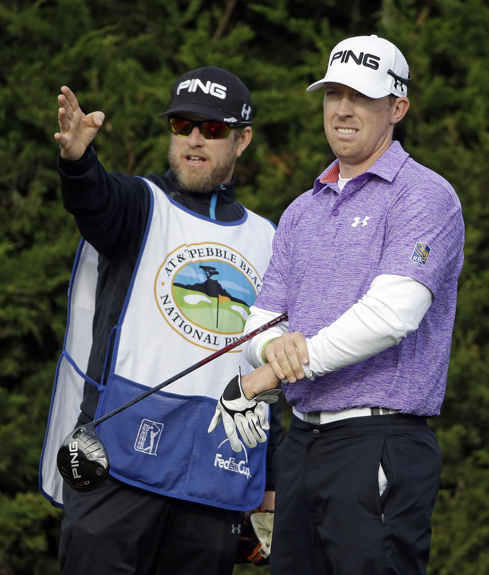 FILE - Hunter Mahan, right, listens to his caddie John Wood on the second tee during the third round of the AT&T Pebble Beach Pro-Am golf tournament on the Monterey Peninsula Country Club Shore Course in Pebble Beach, Calif on Feb. 8, 2014. Wood has been appointed team manager for the U.S. Ryder Cup team. (AP Photo/Ben Margot, File)