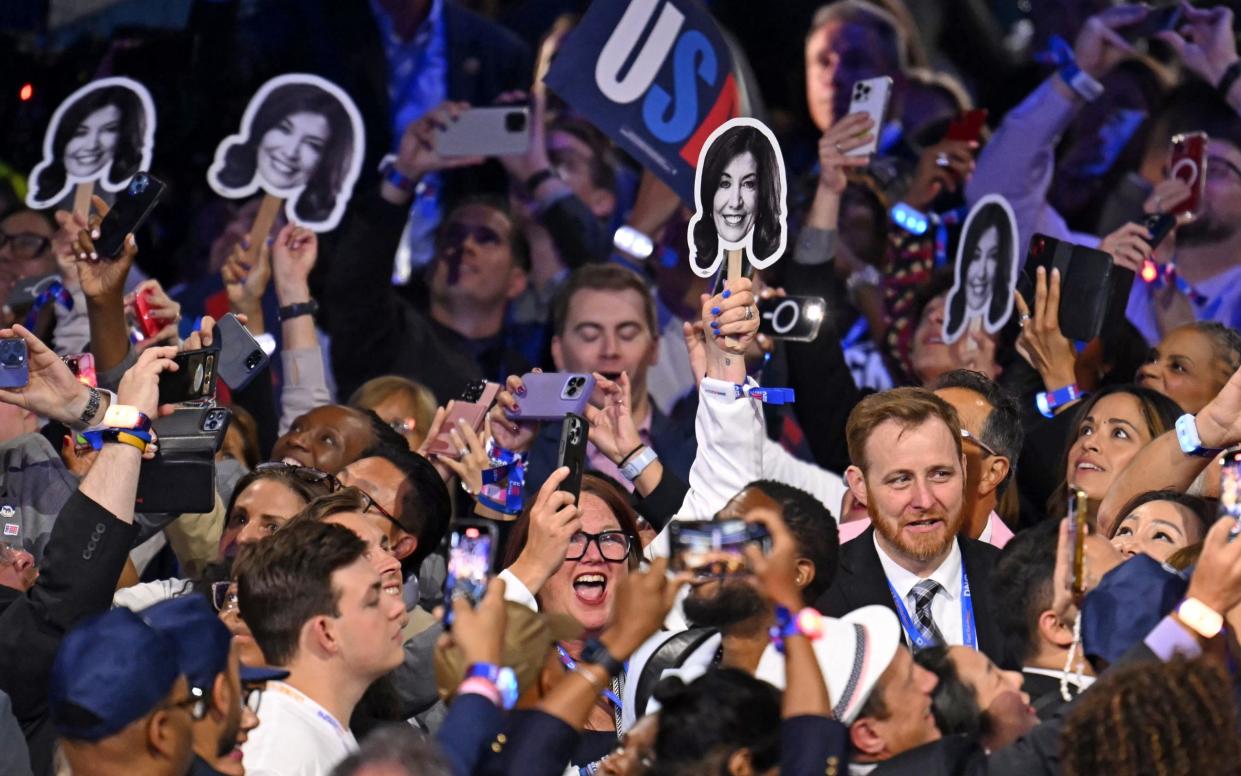 New York delegation members hold pictures of New York Governor Kathy Hochul during the ceremonial roll call