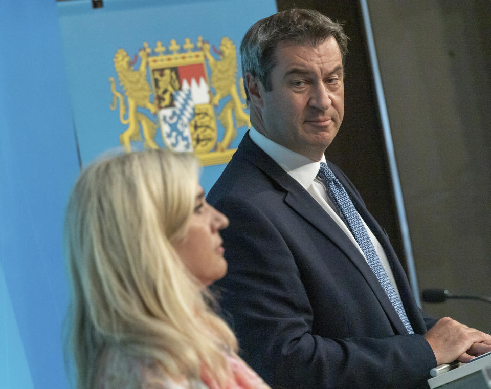 Melanie Huml, Health Minister of the German state of Bavaria, left, and Bavaria's governor Markus Soeder, right, address the media during a joint press conference in Munich, Germany, Thursday, Aug. 13, 2020. (Peter Kneffel/dpa via AP)