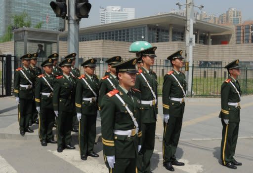 Chinese military policemen are seen marching to change guard outside the US Embassy (background building) in Beijing where blind rights activist Chen Guangcheng is believed to be hiding, on May 2. US Secretary of State Hillary Clinton arrived in Beijing for talks with Chinese leaders that risk being overshadowed by the case of Chen