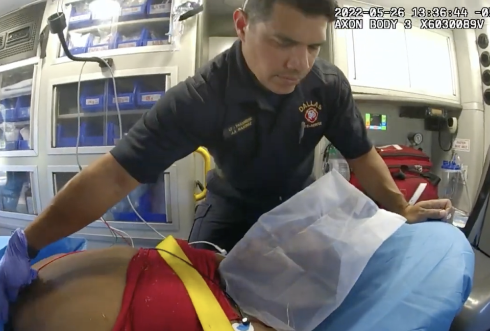 A crewmember with Dallas Fire-Rescue checks LaDamonyon Dewayne Hall on the way to hospital. She stopped breathing soon afterwards (Dallas Police Department)