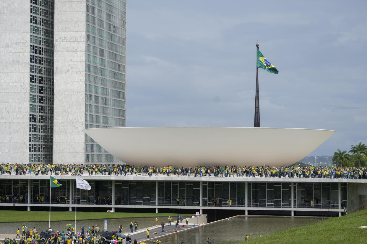 Protesters, supporters of Brazil's former President Jair Bolsonaro, storm the the National Congress building in Brasilia, Brazil, Sunday, Jan. 8, 2023. (AP Photo/Eraldo Peres)