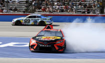Martin Truex Jr. spins as Daniel Suarez (99) drives past during the NASCAR Cup Series auto race at Texas Motor Speedway in Fort Worth, Texas, Sunday, Sept 25, 2022. (AP Photo/Randy Holt)