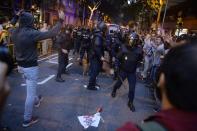 <p>Pro-referendum demonstrators protest as Spanish National Police officers leave during a demonstration near the Economy headquarters of Catalonia’s regional government in Barcelona on Sept. 20, 2017. (Photo: Lluis Gene/AFP/Getty Images) </p>