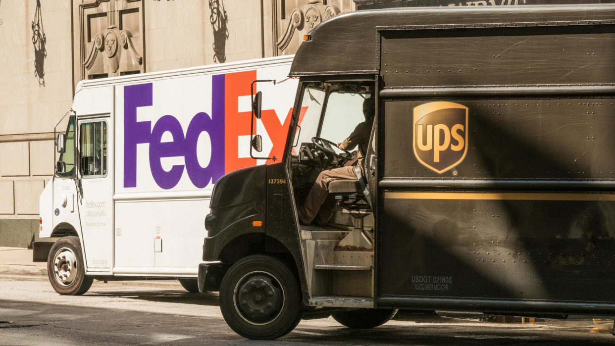 Chicago, USA - September 11, 2015: A UPS delivery truck passing a FedEx truck on Michigan Avenue in the Loop late in the day in front of Lawrys.