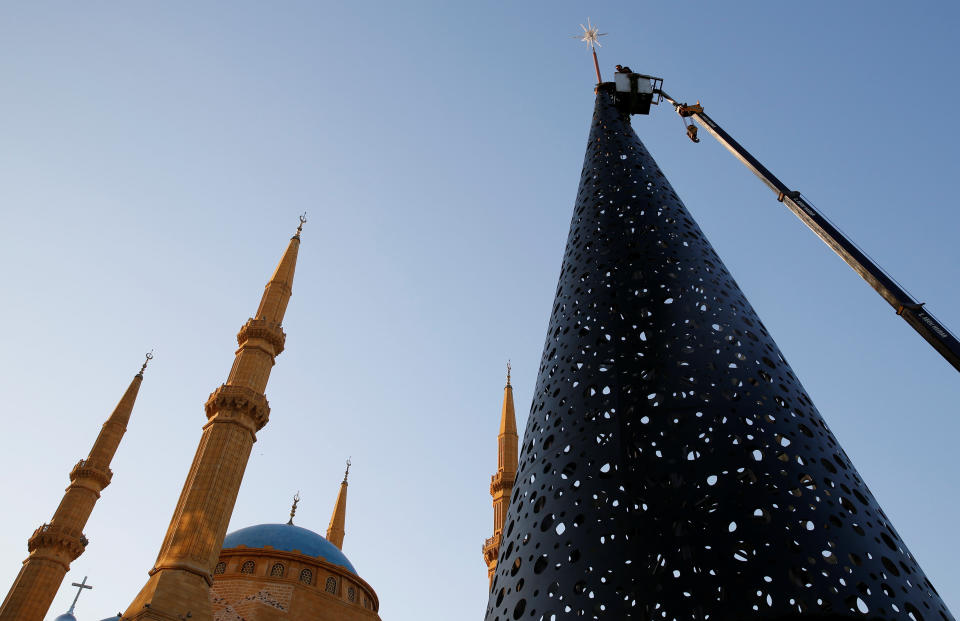 Workers decorate a Christmas tree in front of the Al-Amin mosque in Beirut, Lebanon.