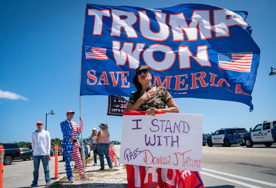 Former president Donald Trump supporter Cindy Falco DiCorrado prays across from Mar-a-Lago in Palm Beach, Florida on March 21, 2023.