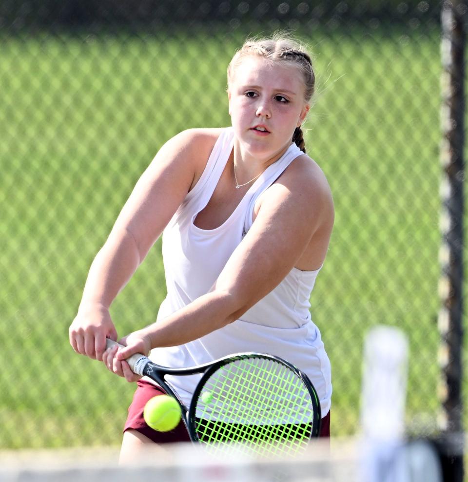 Falmouth number two singles player Genevieve Maranchie digs out a low show against Barnstable.