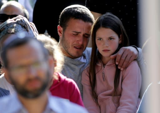 Mourners attend the funeral of 47-year-old rabbi Ahiad Ettinger, who died from wounds sustained in the attack in the West Bank