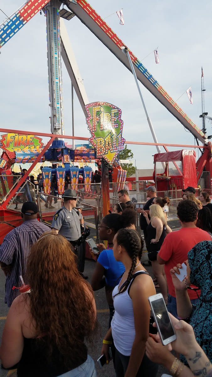 <p>People watch as authorities respond near the Fire Ball amusement ride after the ride malfunctioned injuring several at the Ohio State Fair, Wednesday, July 26, 2017, in Columbus, Ohio. Some of the victims were thrown from the ride when it malfunctioned Wednesday night, said Columbus Fire Battalion Chief Steve Martin. (Justin Eckard via AP) </p>