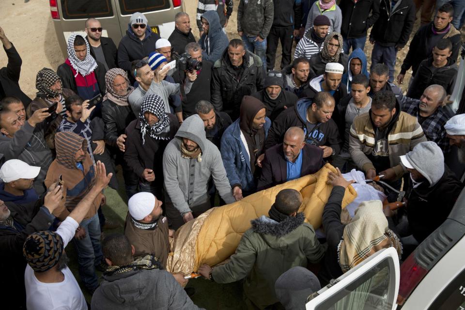 Bedouin men carry the body of Yaakub Abu al-Qiyan during his funeral in the Bedouin village of Umm al-Hiran, in the Negev desert, southern Israel, Tuesday, Jan. 24, 2017. Last Wednesday Israeli police said al-Qiyan, an Israeli Arab, rammed his vehicle into a group of police officers, killing one of them, before he was shot dead during clashes in southern Israel over a court-ordered operation to demolish illegally built homes. (AP Photo/Ariel Schalit)