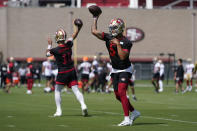 San Francisco 49ers quarterbacks Trey Lance (5) and Jimmy Garoppolo (10) throw passes at NFL football training camp in Santa Clara, Calif., Wednesday, July 28, 2021. (AP Photo/Jeff Chiu)