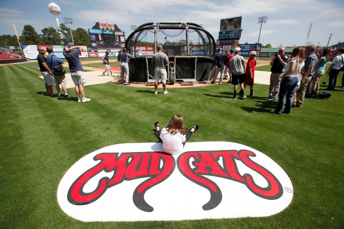 A 2013 file photo showing 6-year-old Emma Strickland enjoying front row seating to pre-game warmups during an exhibition game between the Carolina Mudcats and the Cleveland Indians.