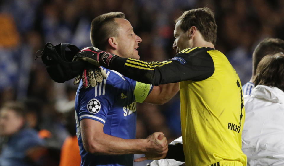 Chelsea's John Terry, left goes to hug Chelsea goalkeeper Petr Cech after Chelsea defeated Paris Saint-Germain in the Champions League quarterfinal second leg soccer match between Chelsea and Paris Saint Germain at Stamford Bridge stadium in London, Tuesday, April 8, 2014. Chelsea advance to the semifinals. (AP Photo/Matt Dunham).