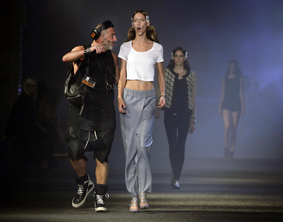 Fashion show producer Etienne Russo, left, from Brussels, schools a model during rehearsal for the Prabal Gurung Spring 2013 collection, during Fashion Week in New York, Saturday, Sept. 8, 2012. (AP Photo/Richard Drew)