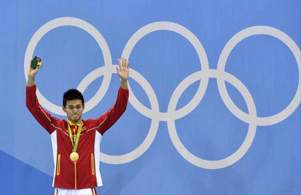 FILE - In this file photo dated Monday, Aug. 8, 2016, China's gold medal winner Sun Yang waves during the medal ceremony for the men's 200-meter freestyle final during the swimming competitions at the 2016 Summer Olympics, in Rio de Janeiro, Brazil.  China’s star swimmer Sun Yang risks being banned from the Tokyo Olympics for the alleged destruction of a doping control sample, according to information made available Wednesday March 13, 2019, from the Court of Arbitration for Sport.(AP Photo/Martin Meissner, FILE)